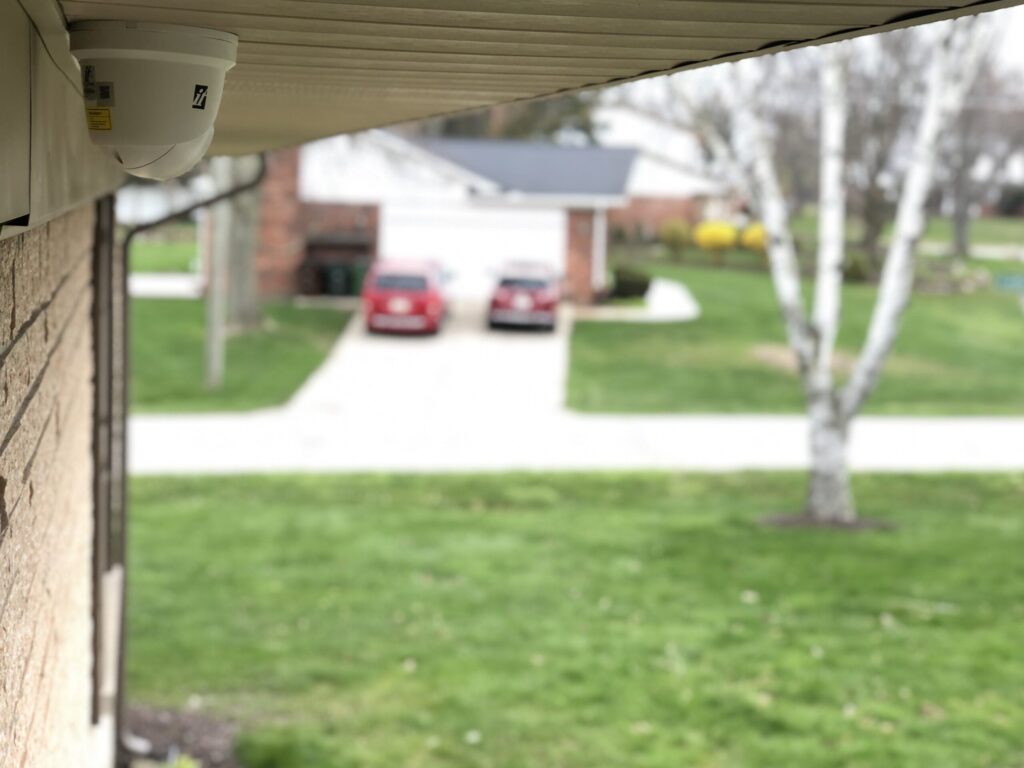 Dome security camera mounted under a building eave