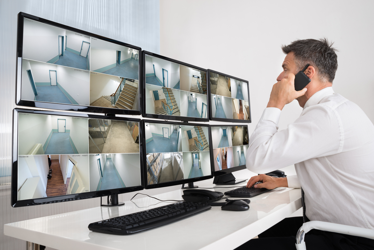 Security operator monitoring CCTV camera screens